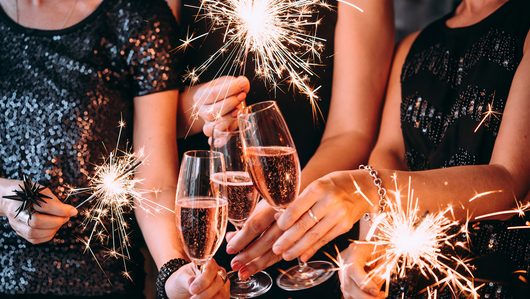 Group of people cheering with Champagne and sparklers