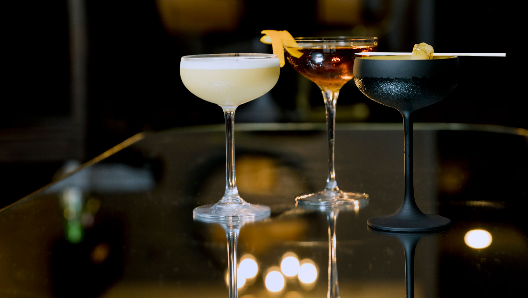 Three cocktails on a bar at a Kimpton Restaurant