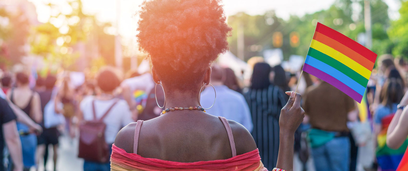 Black woman holding a pride flag